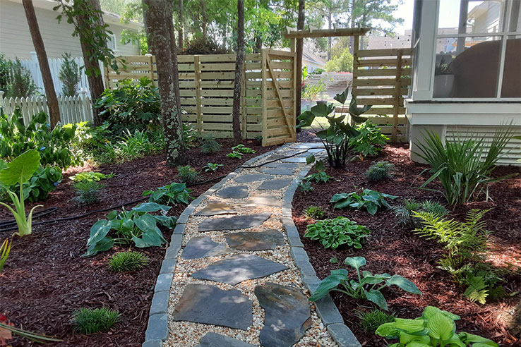 A walkway and garden showing off Long Leaf Organics' hardscape and landscape skills.